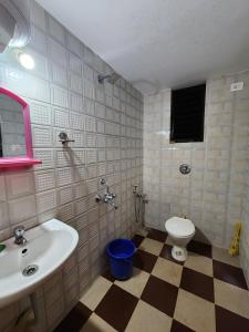 a bathroom with a sink and a toilet at Serene Green Park in Canacona