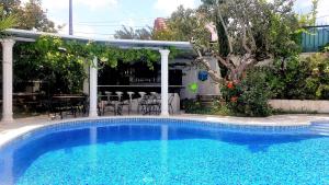 a swimming pool in a yard with a patio at Silver Coast Pool & Resort Villas in Arnal