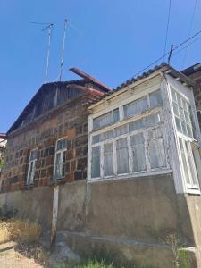 an old brick building with windows on it at Riverside Hostel in Gyumri