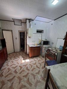 a room with a kitchen with a stove and a counter at Riverside Hostel in Gyumri