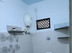 a bathroom with a shower with a fan and a window at Mannath lands end Beach house in Kaup +41 photos