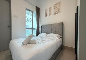 a large white bed in a bedroom with a window at K&L Suites Razak City Kuala Lumpur in Kuala Lumpur