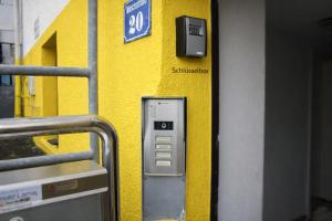 a yellow wall with a pay phone on a subway at Kleine Wohnung für Singles in Daun +14 photos