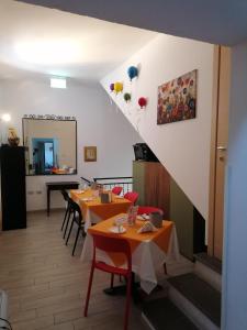 a restaurant with tables and chairs and a staircase at Hotel Centrale in Cascia