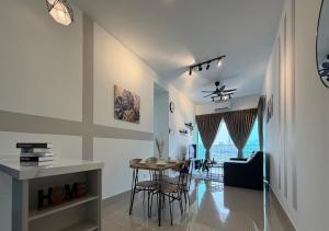 a kitchen and living room with a table and chairs at K&L Suites Razak City Kuala Lumpur in Kuala Lumpur