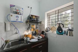 a small kitchen with a sink and a window at Prakash Nilayam Studio I - Kondapur in Lingampalli +11 photos