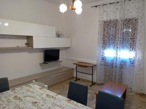 a dining room with a table and a television at La Casa di Rossella in Scanno