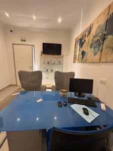 an office with a blue desk with a computer on it at Lux Maris in Mazara del Vallo