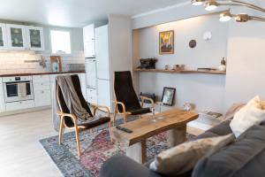 a living room with a wooden table and chairs at Toftenäs apartment in Toftenäs