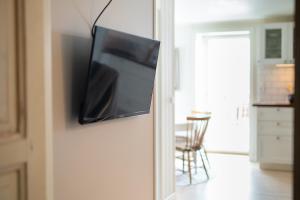 a television hanging on a wall in a room at Toftenäs apartment in Toftenäs
