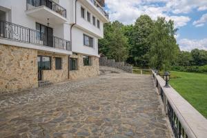 a stone walkway in front of a building at Villa High Point in Pravets