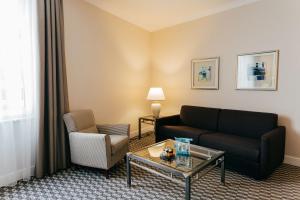 a living room with a couch and a coffee table at Radisson Blu Carlton Hotel, Bratislava in Bratislava