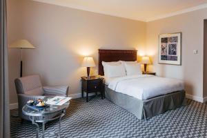 a hotel room with a bed and a chair at Radisson Blu Carlton Hotel, Bratislava in Bratislava