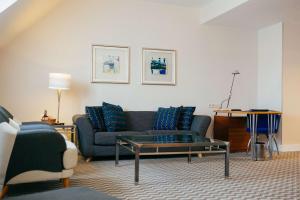 a living room with a couch and a table at Radisson Blu Carlton Hotel, Bratislava in Bratislava +123 photos