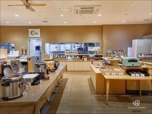 a large kitchen with tables and counters in a store at Daiwa Roynet Hotel Numazu in Numazu