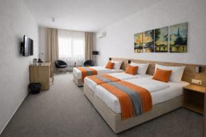 a hotel room with two beds and a desk at Hotel Kapitol in Most +73 photos