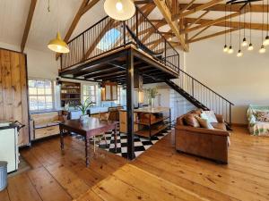 a living room with a staircase in a house at Pekárna in Vosburg