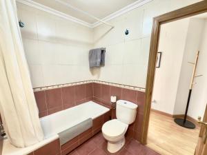 a bathroom with a toilet and a bath tub at La Encarnación in Ávila