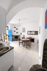a kitchen and dining room with a table and chairs at Aeolian Apartments in Lipari