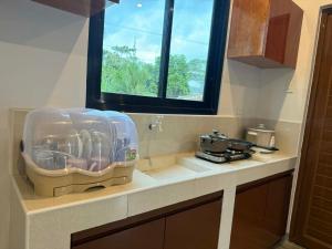 a kitchen counter with a container of utensils at New Apartment in Panglao Island