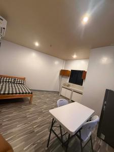 a room with a bed and a table and chairs at New Apartment in Panglao Island