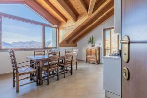 a kitchen and dining room with a table and chairs at Il Nido sul Lago in Perledo