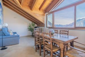 a dining room with a table and chairs and a window at Il Nido sul Lago in Perledo