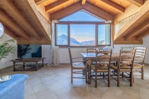 a dining room with a table and chairs and a large window at Il Nido sul Lago in Perledo +34 photos