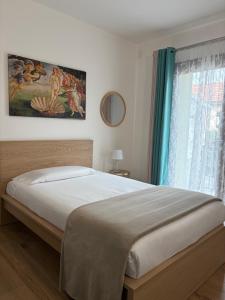 a bedroom with a bed and a window at CENTRALE in Orio al Serio
