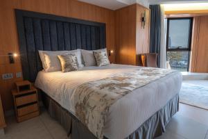 a bedroom with a large bed with a black headboard at Iconic Plaza Hotel in Nairobi +24 photos