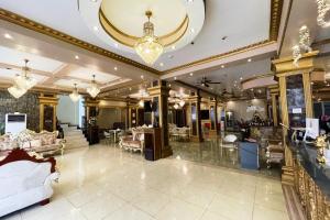 a large lobby with furniture and a chandelier at Clark Imperial Hotel Angeles City in Angeles +7 photos