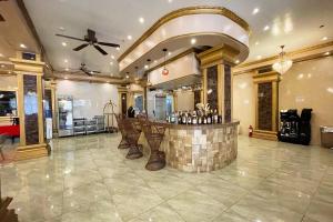 a bar in a large room with a ceiling at Clark Imperial Hotel Angeles City in Angeles