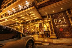a car parked in front of a building at night at Clark Imperial Hotel Angeles City in Angeles