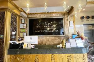 a restaurant with a sign on the front of a counter at Clark Imperial Hotel Angeles City in Angeles