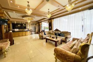 a large living room with couches and a table at Clark Imperial Hotel Angeles City in Angeles