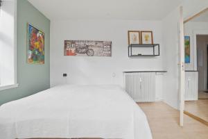 a white bedroom with a large white bed in it at Apartment in central Holstebro in Holstebro