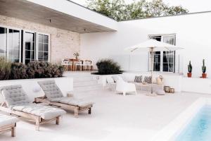 a patio with white furniture and a swimming pool at Villa Sunrise Labin Istria - a smile every day in Nedeščina