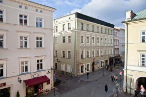 a group of buildings on a street in a city at P&J Apartamenty Grodzka in Kraków