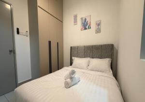 a bed with a pair of shoes sitting on it at K&L Suites Razak City Kuala Lumpur in Kuala Lumpur