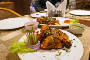 a table with two plates of food on it at S by Z Hotels, Baani Square in Gurgaon