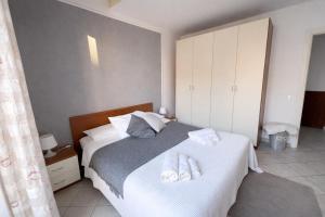 a bedroom with a bed with two towels on it at Jacuzzi Suite in Livorno +12 photos