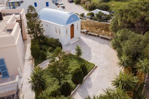 an aerial view of a building with trees and bushes at Seashore Villas Tinos in Tinos