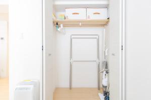 a bathroom with a door and a toilet in a room at mks102 in Sapporo +46 photos