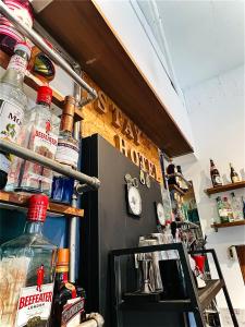 a bar with bottles of alcohol on the wall at Stay Hotel in Xiaoliuqiu