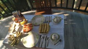 a table with plates and utensils on a table at Lucky Palace in Beruwala