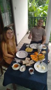 a man and woman sitting at a table with food at Lucky Palace in Beruwala +13 photos