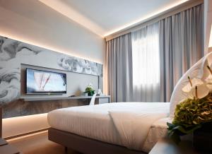 Postel nebo postele na pokoji v ubytování Hotel Glance In Florence