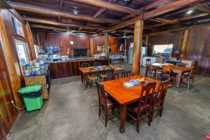 a dining room with wooden tables and chairs at Kin Kin Retreat in Quinninup