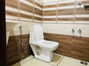 a bathroom with a toilet and a sink at Clement homes in Kalpetta