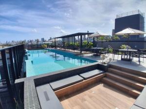 a swimming pool on the roof of a building at Flat Beach Haus a beira mar João pessoa in João Pessoa